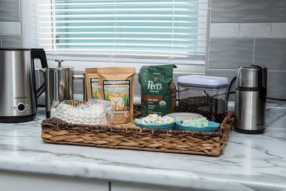 Our newly renovated kitchen is outfitted with sleek stainless steel appliances and fully stocked with plenty of cups, dishes, and a variety of pots and pans for cooking. A dedicated coffee station provides everything you need for your morning brew.