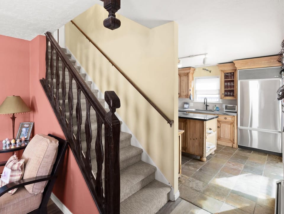 The view from the living towards the kitchen and the stairs leading to the third floor.
