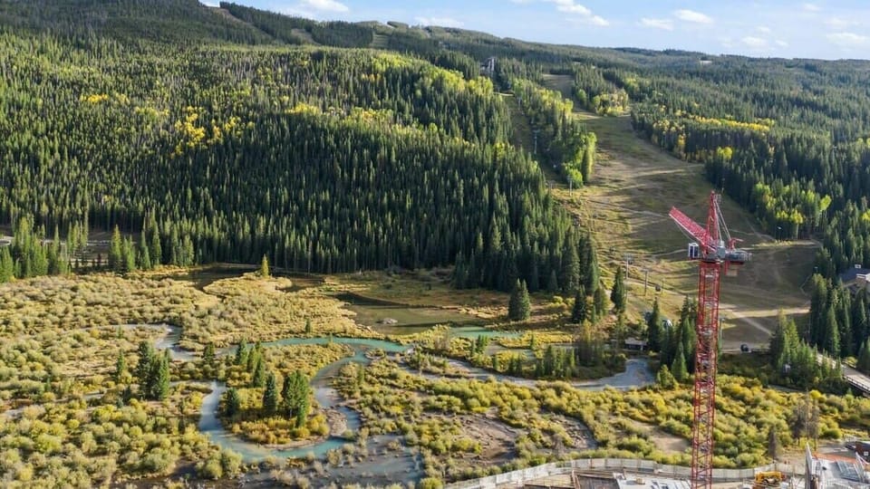 The scenery surrounding the condo is beautiful with trees, mountain views, and a lovely stream running past.