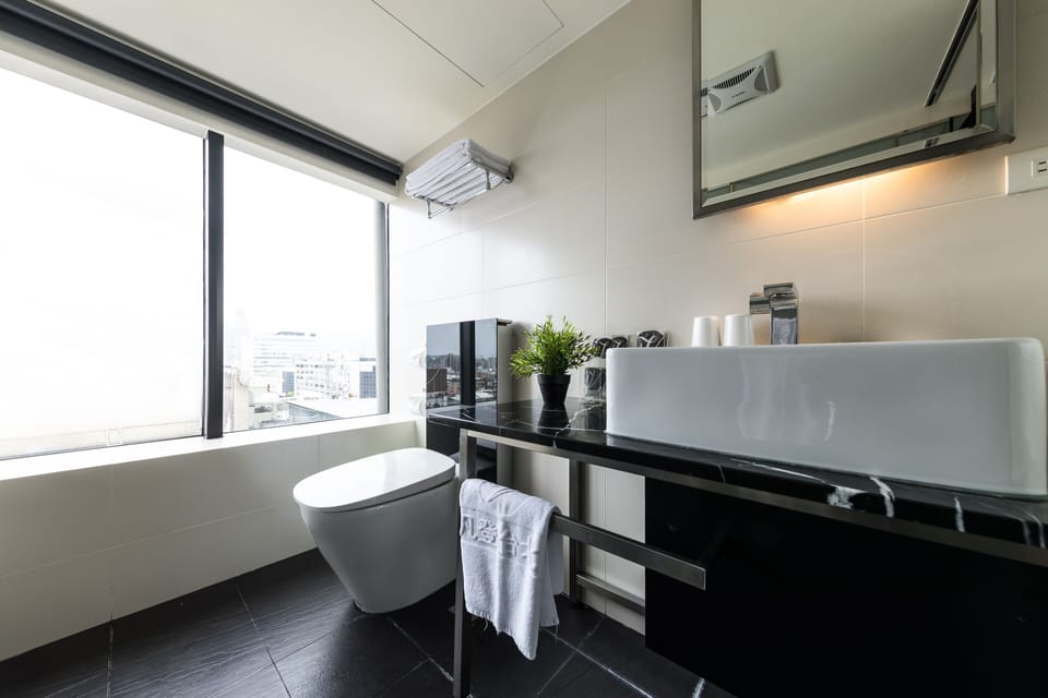 Deluxe Room | Bathroom | Hair dryer, slippers