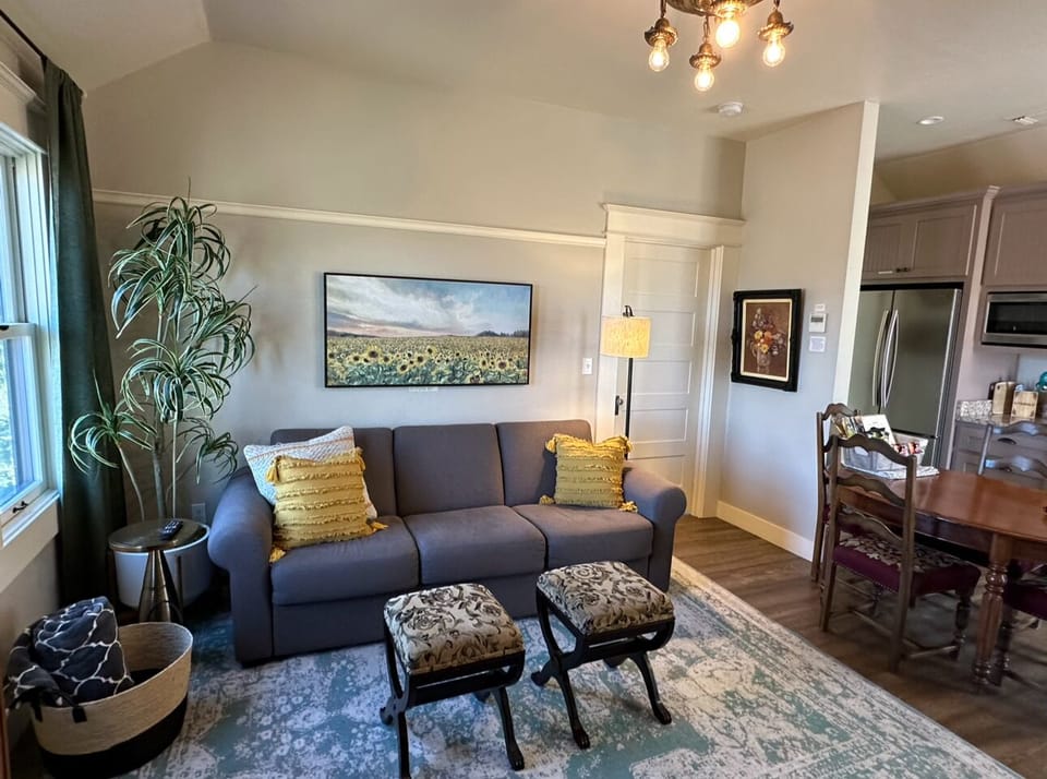 Spacious interior featuring a stylish living room setup with sunflower-themed artwork.