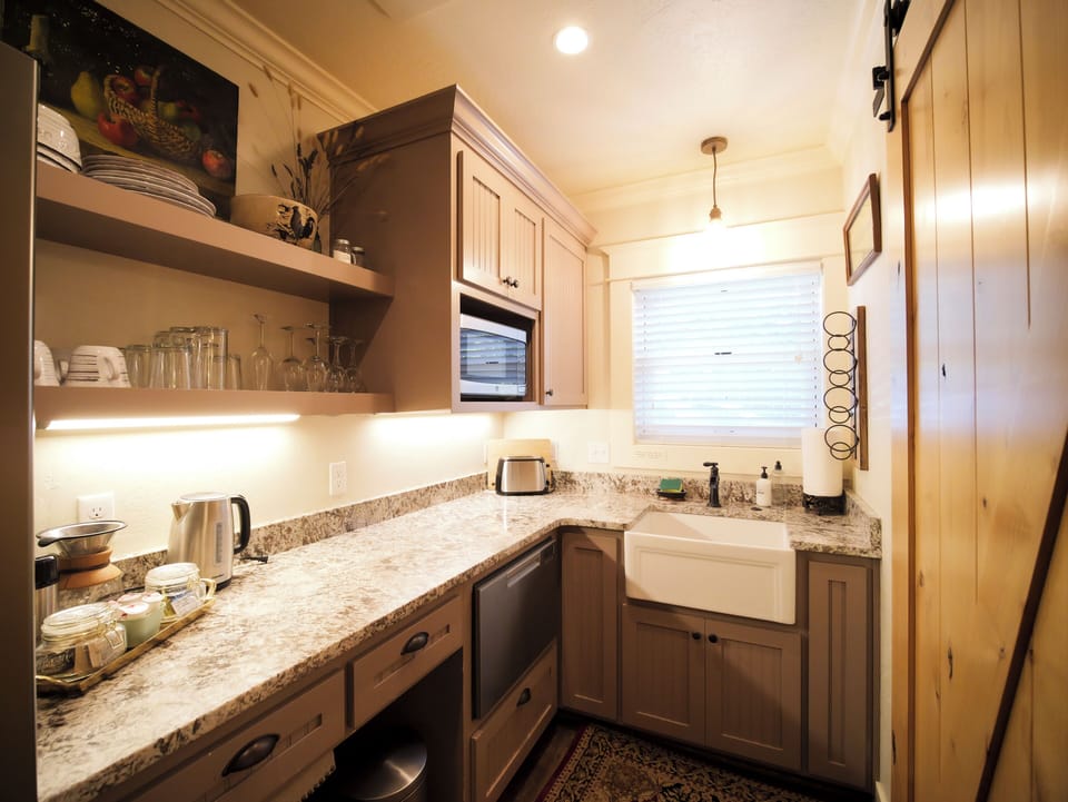 A fully stocked kitchen featuring modern amenities and rustic details.