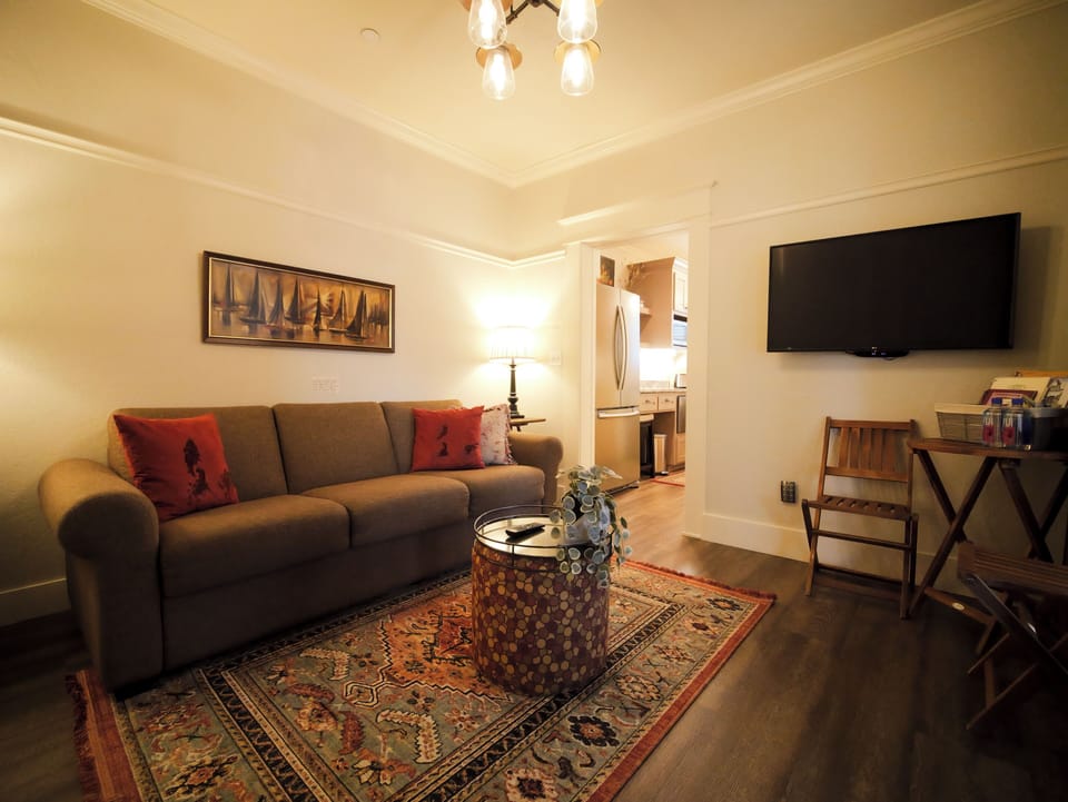 Cozy up in the inviting living room with warm lighting and classic decor.