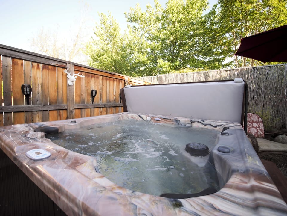 A bubbling hot tub for ultimate relaxation under the open sky.
