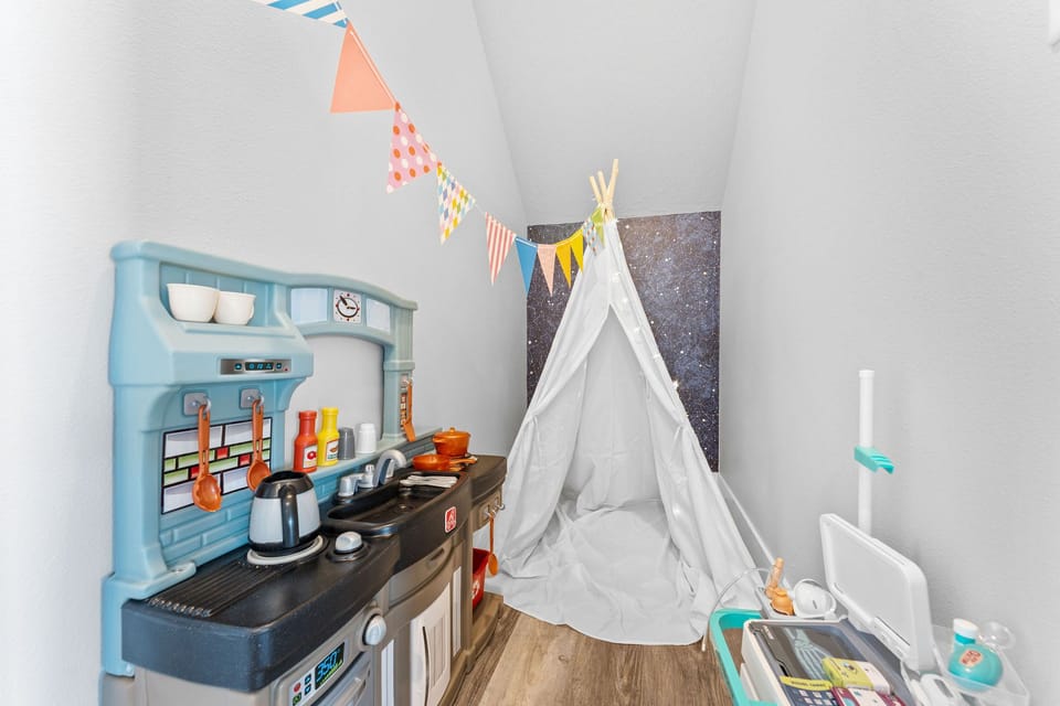 A cozy kids-only hideaway featuring a teepee, playsets, and plenty of space for imagination to run wild.
