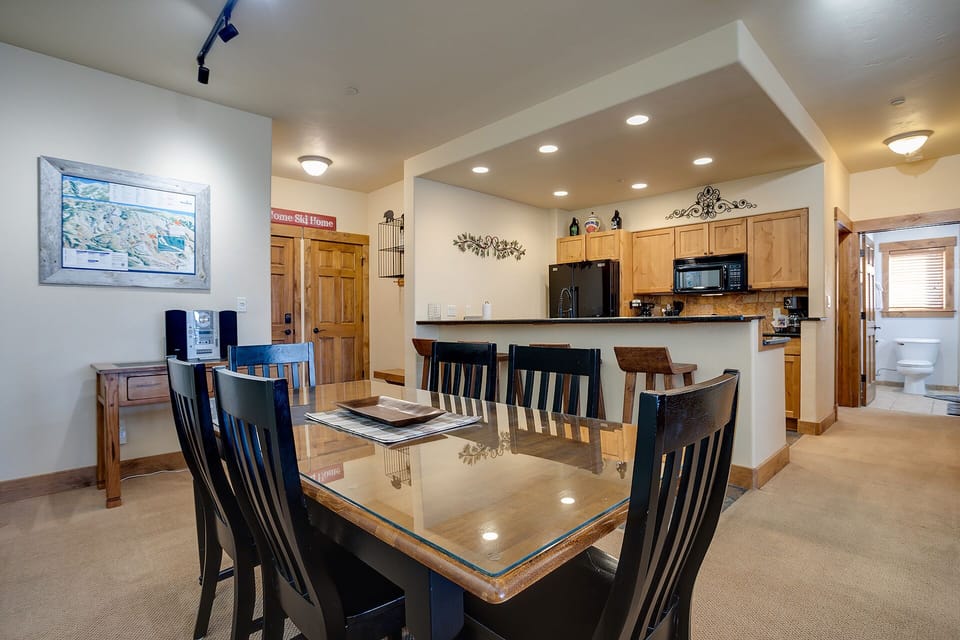 Gather around your spacious dining table with mountain views while the modern kitchen beckons for culinary adventures together.