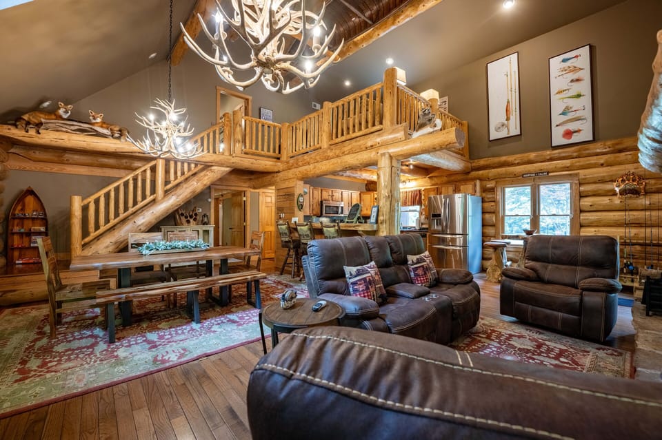 Living room with plenty of seating. There is a TV not pictured.