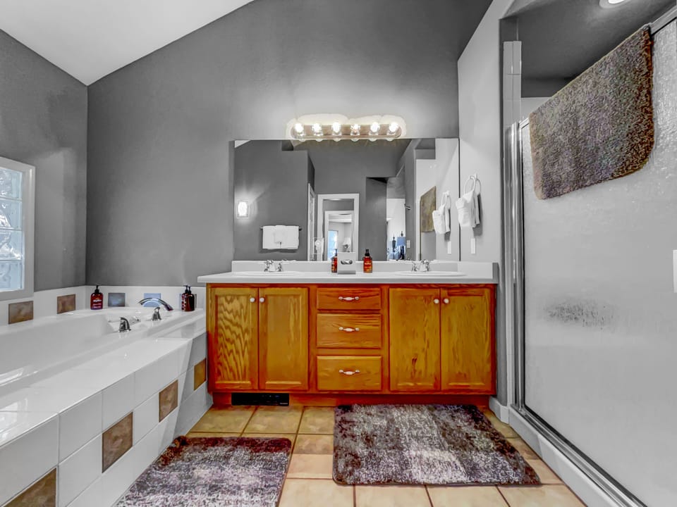 Master bedroom bathroom with jacuzzi tub, 2 vanity, and walk-in shower.