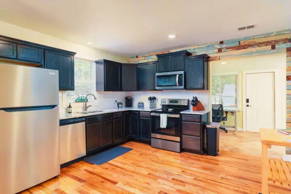 Full kitchen with dishwasher, microwave and stunning hardwoods. Electric stove.