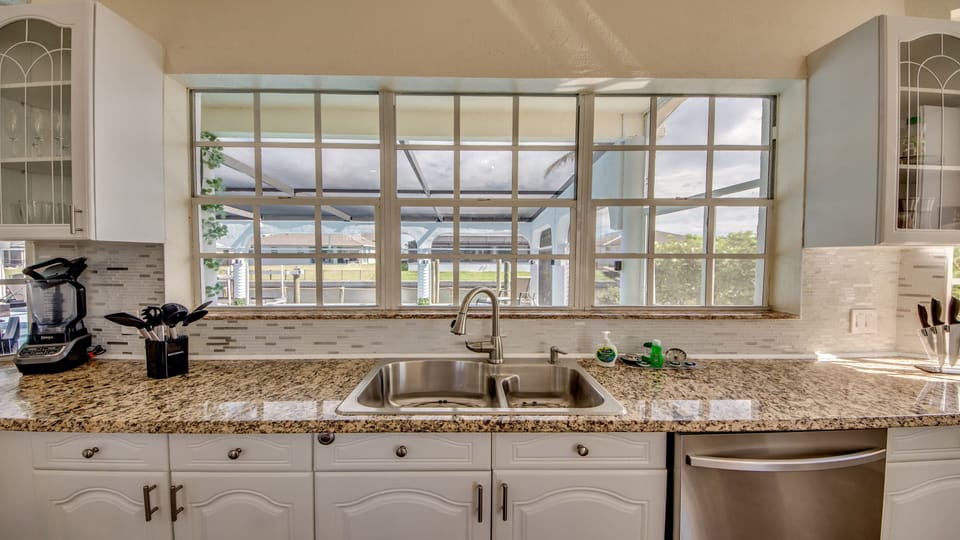 Large kitchen with view to the pool and terrace