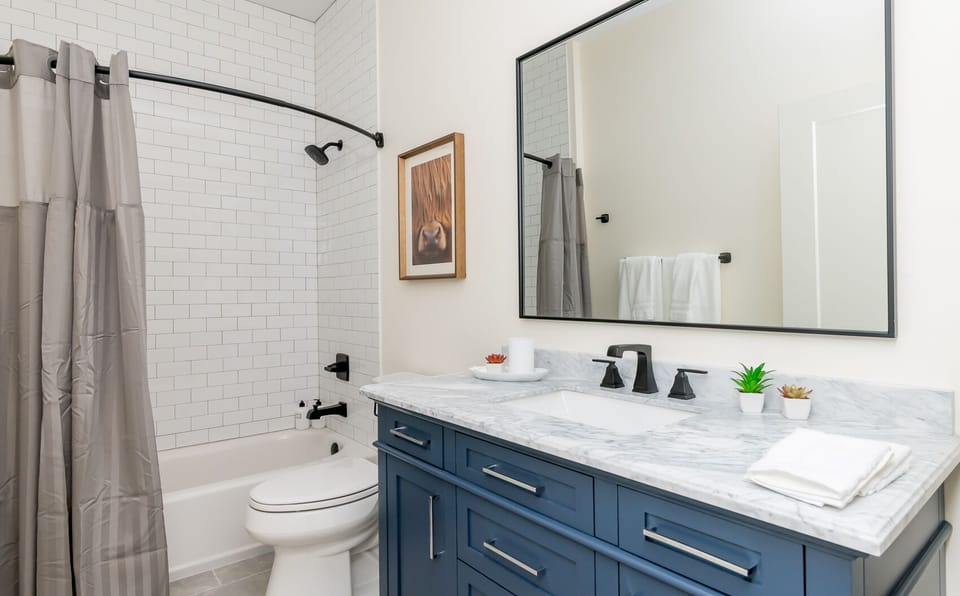 Full bathroom with shower/tub and large vanity