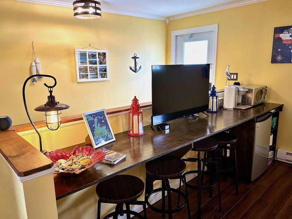 Dining/work area with HDTV, coffeemaker, microwave, and mini-fridge