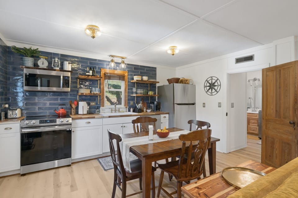 Kitchen looking into second bathroom with full laundry