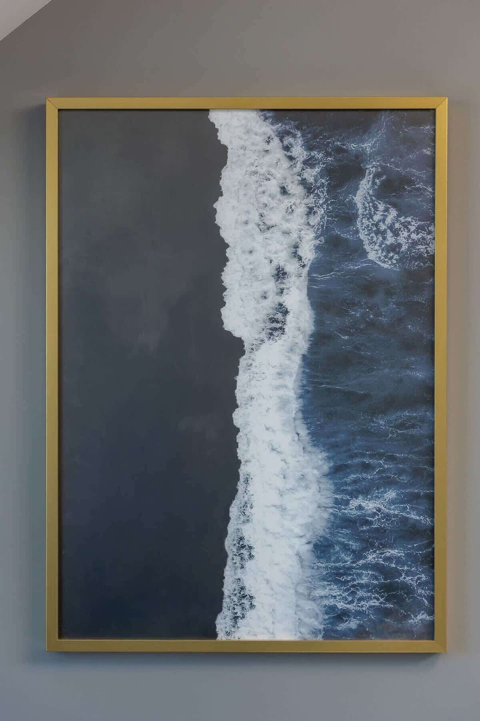 A canvas painting in a wooden frame depicting an abstract vertical scene, possibly a waterfall.