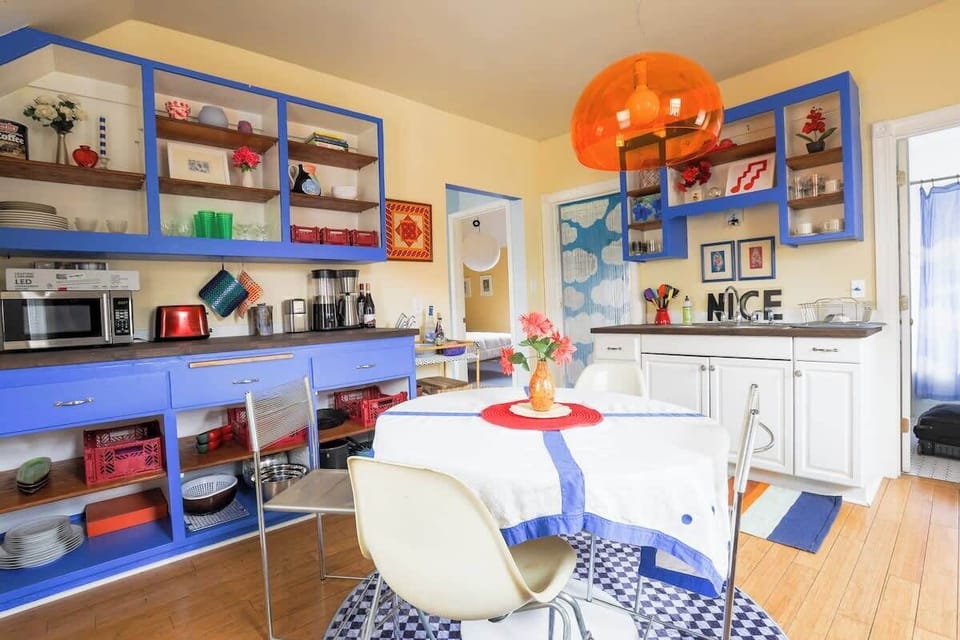 Bright kitchen with electric blue cabinetry and eating space.