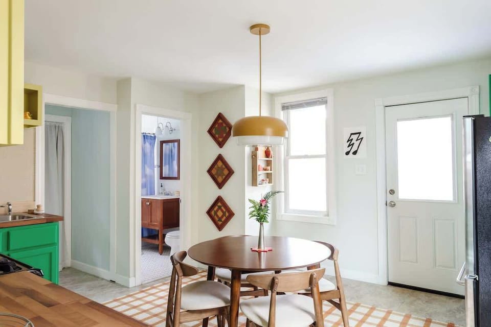 Bright and funky kitchen with mood lighting and round dinning table.