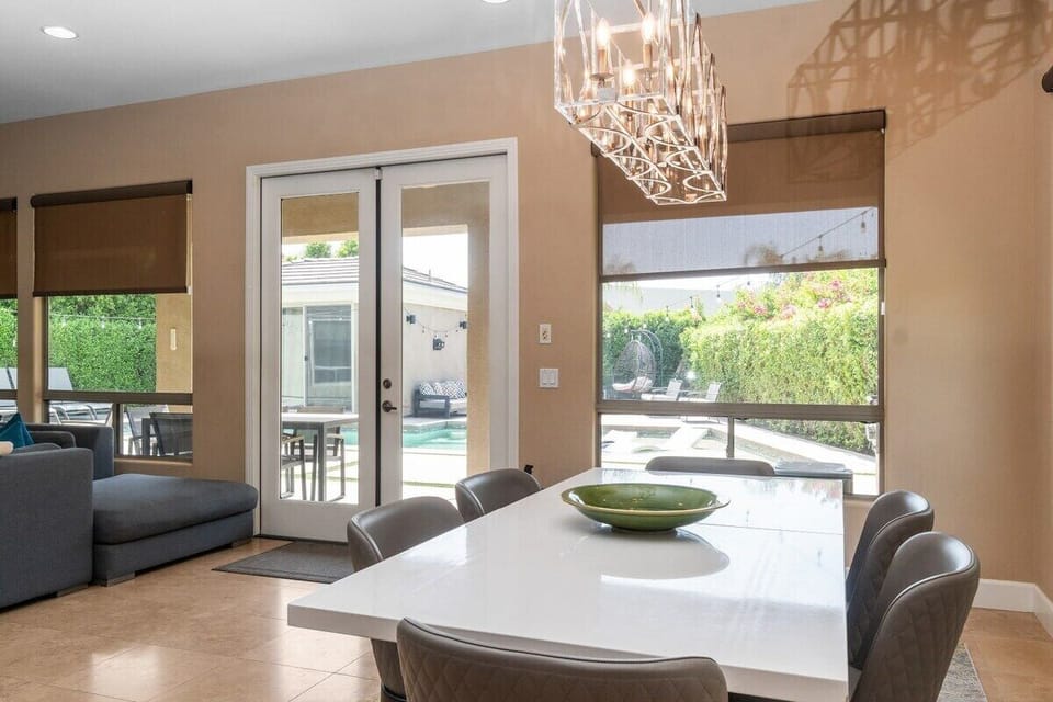 Sliding glass connects indoor meals to outdoor entertaining seamlessly.