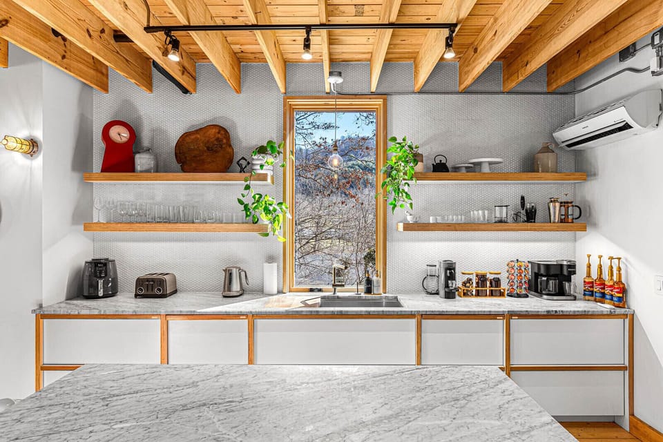 The modern kitchen is perfect for cooking up delicious meals or enjoying a casual breakfast. Enjoy the mountain views while you prepare your favorite dishes.
