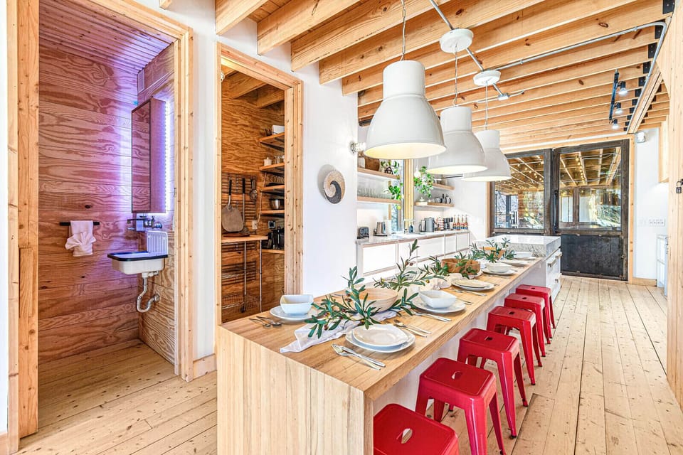 The kitchen features open seating, concrete countertops, pots, pans, cutlery, coffee machines, toaster and more