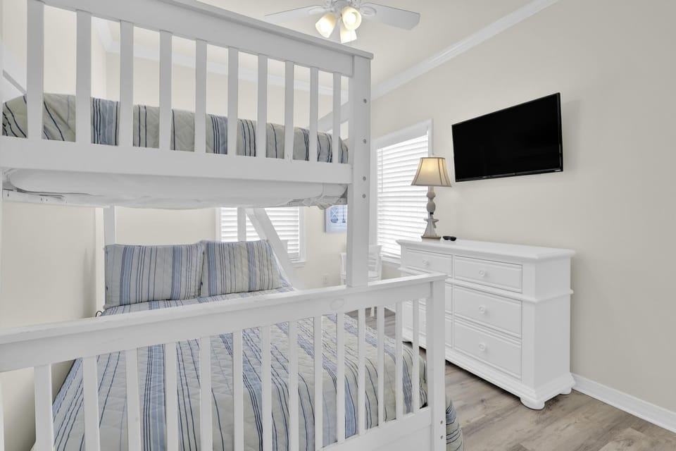 Bedroom 3 - Bedroom 3 features a twin over full bunk bed, a small dresser, and mounted television.