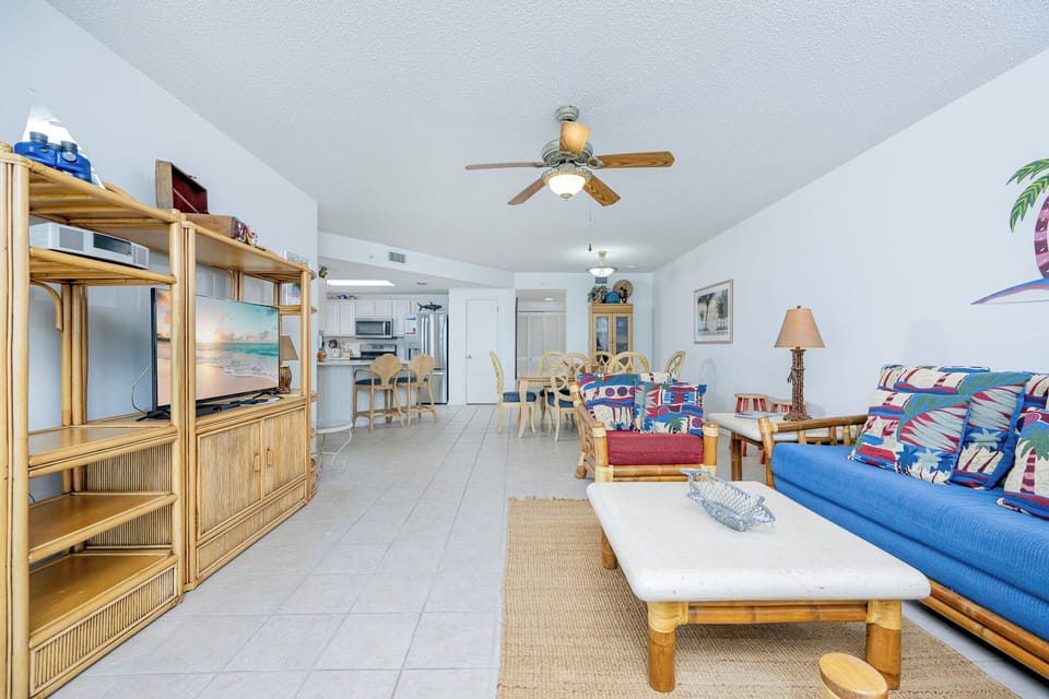 Relax in the inviting living area with colorful decor, sofa with queen sleeper, and easy access to dining and kitchen areas
