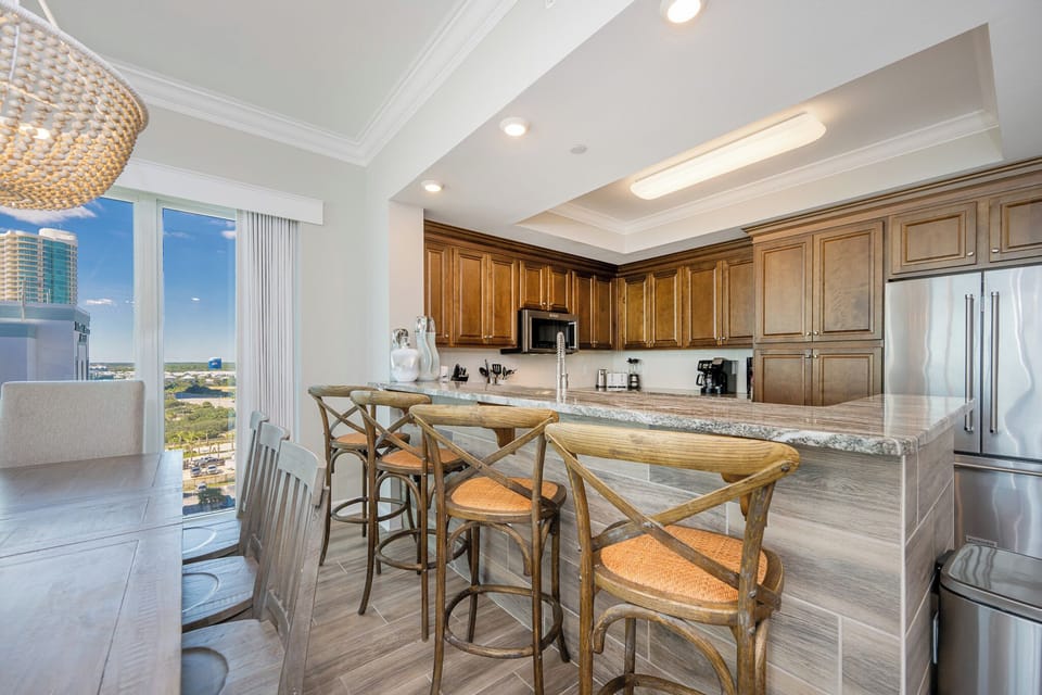 Savor moments at the charming breakfast bar, perfect for casual chats and morning coffee in this inviting kitchen