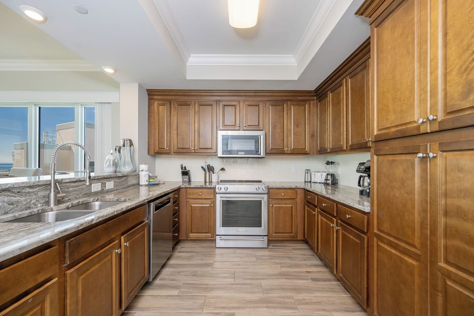 Upgrade your culinary experience in this stylish kitchen with modern stainless appliances and elegant design