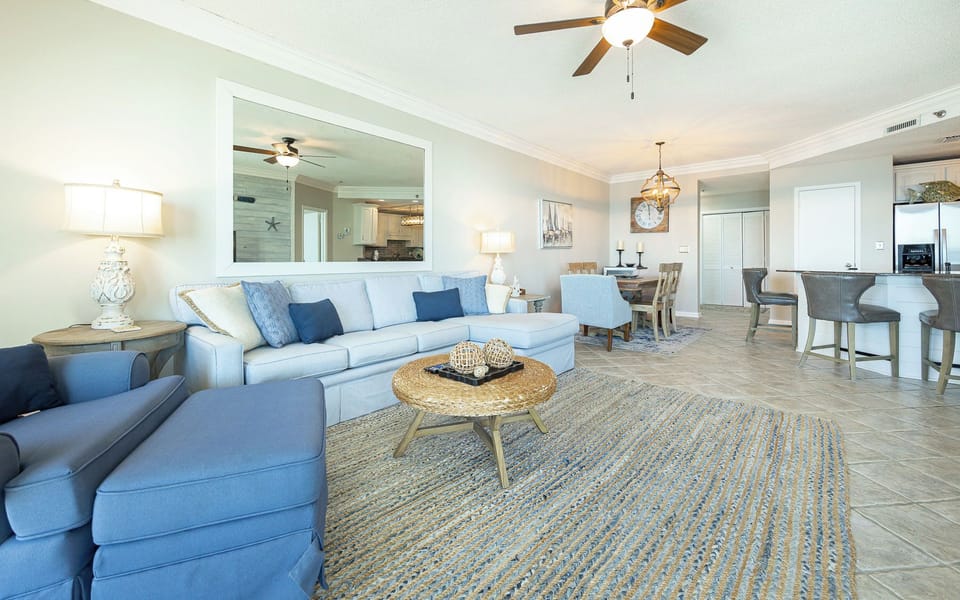 Gather in the inviting living area, where family moments spark joy amidst cozy decor and beach charm