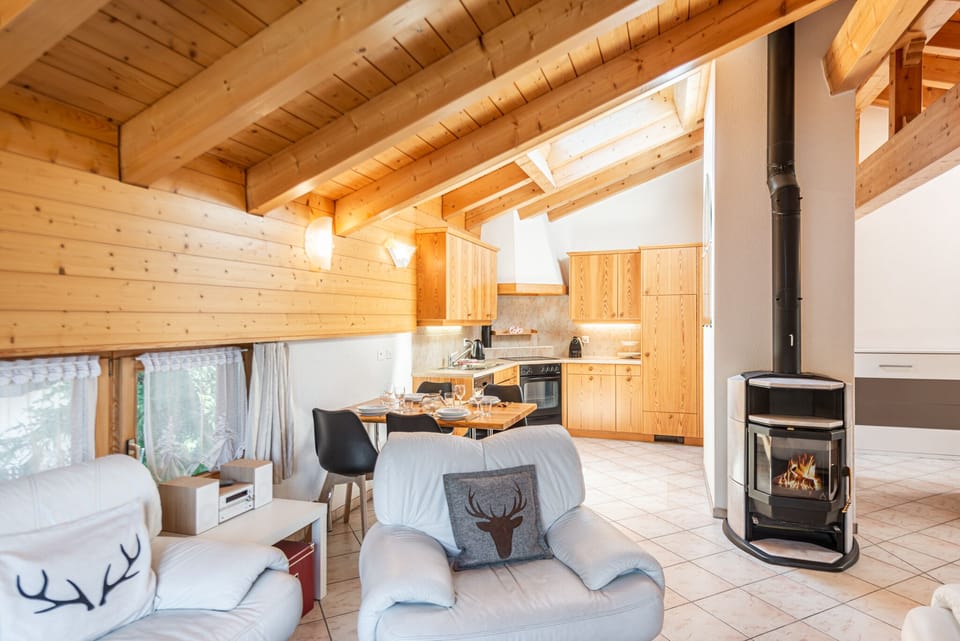 Comfort apartment plus 150 CHF cleaning fee on top of the rate | Living area | 32-inch flat-screen TV with cable channels, fireplace, heated floors