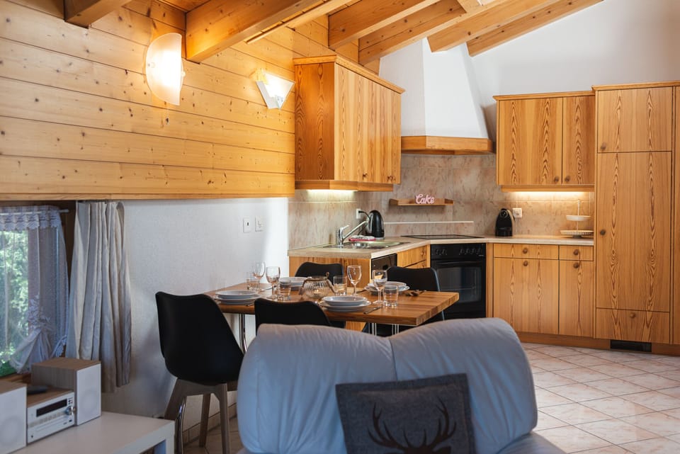 Comfort apartment plus 150 CHF cleaning fee on top of the rate | Living area | 32-inch flat-screen TV with cable channels, fireplace, heated floors