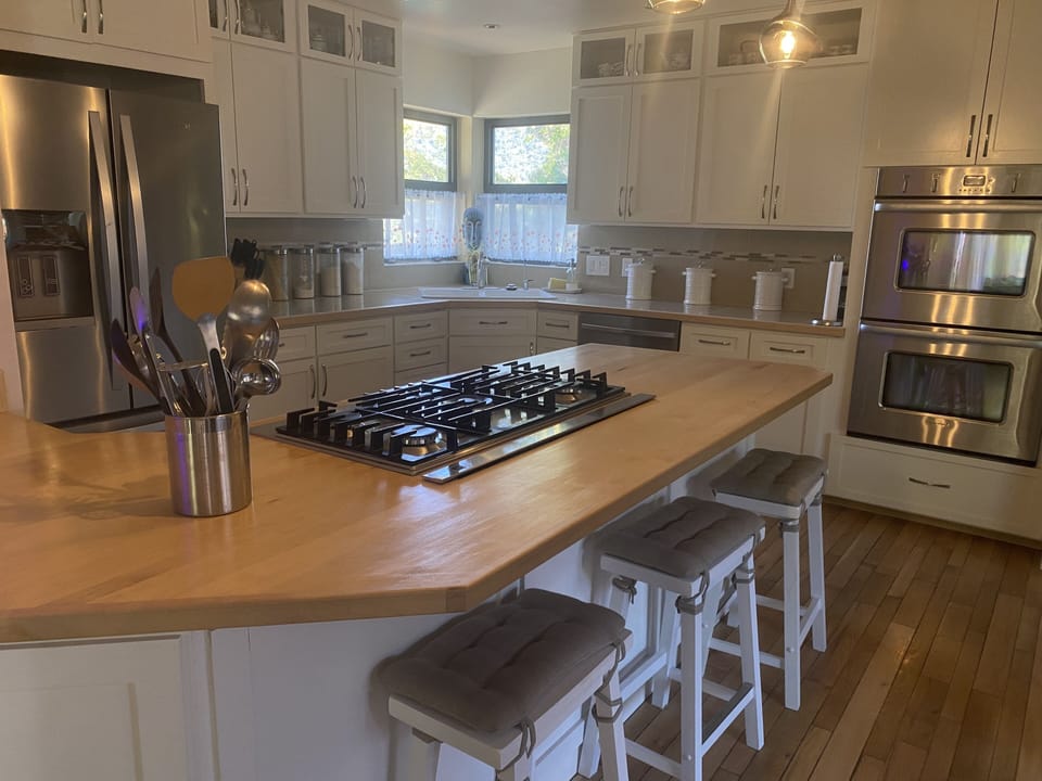 Fully stocked kitchen with two ovens and a separate island gas stovetop 
