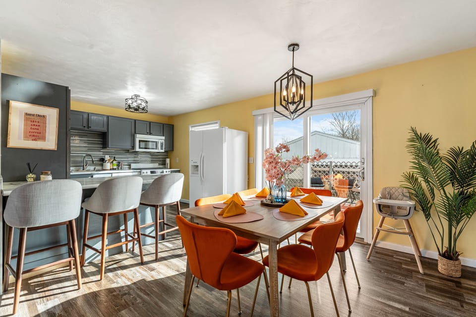 Open concept area featuring kitchen, kitchen island with bar seating, and dining