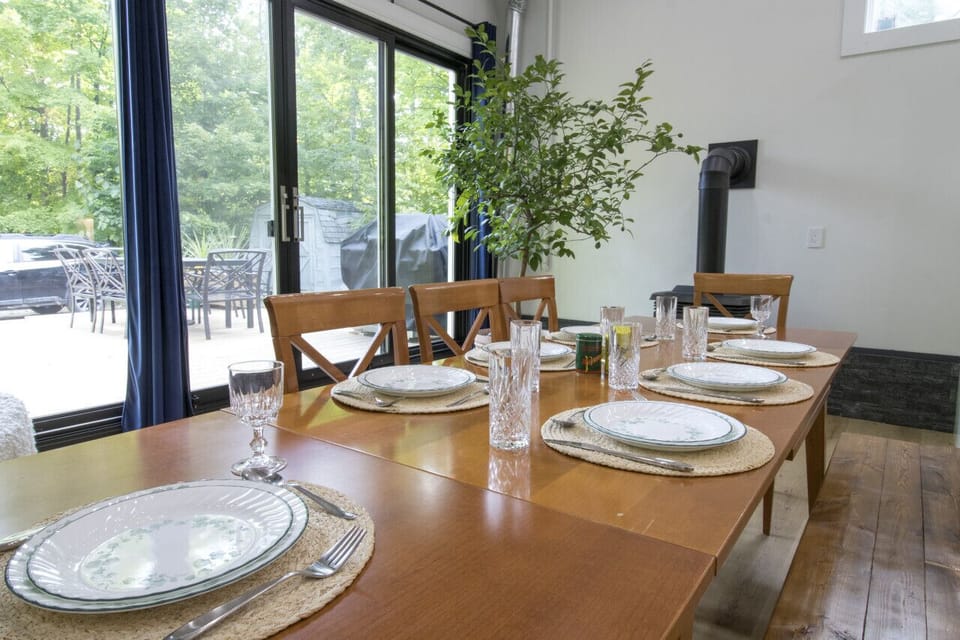 dining table with large windows and gas fireplace