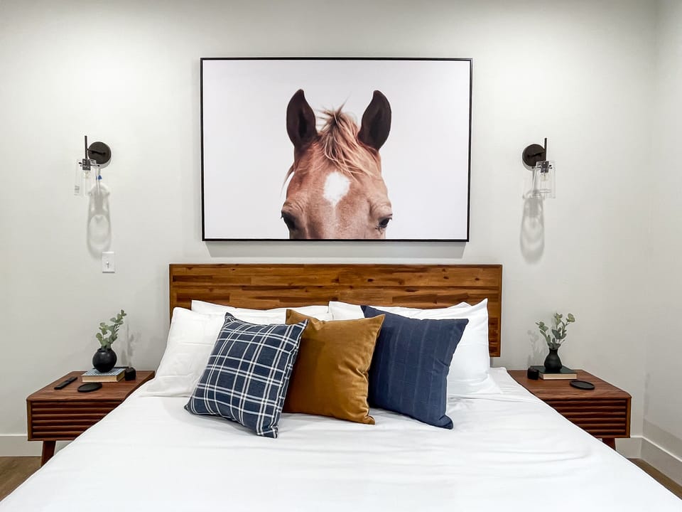 Plush king bed and nightstands in the main level bedroom
