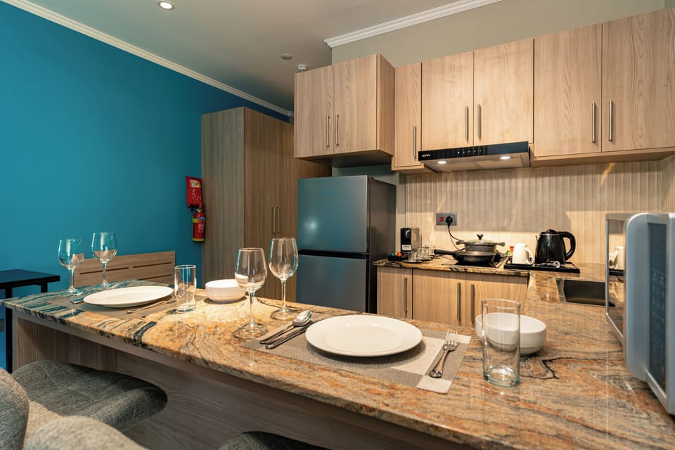 Suite room with Balcony | Private kitchenette | Full-size fridge, microwave, electric kettle, cookware/dishes/utensils