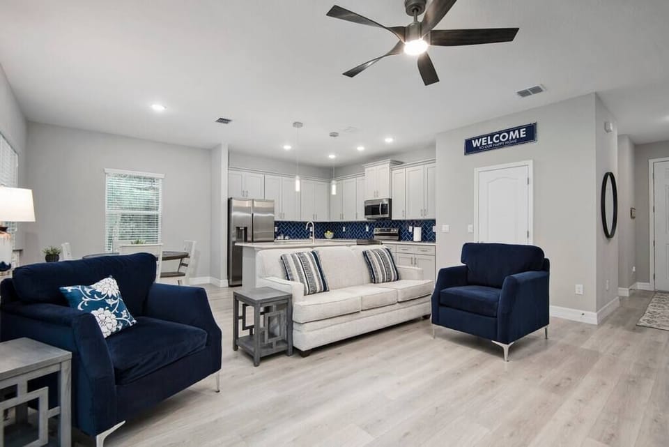 Relax on comfortable living-room seating as ceiling fans circulate air overhead.