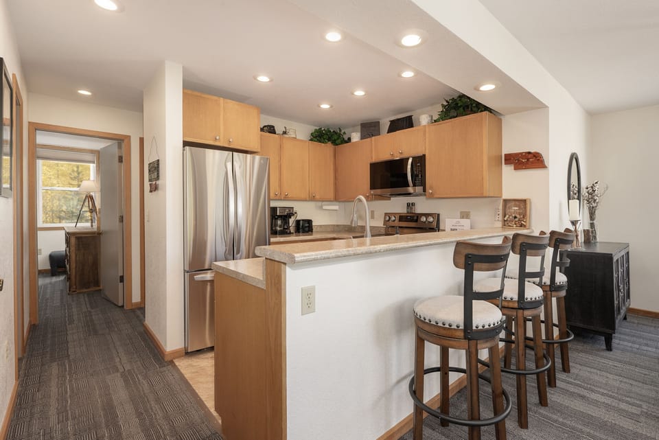 - Kitchen with bar seating and stainless appliances   - Open counter connects to living and dining area   - Convenient layout for meals and entertaining