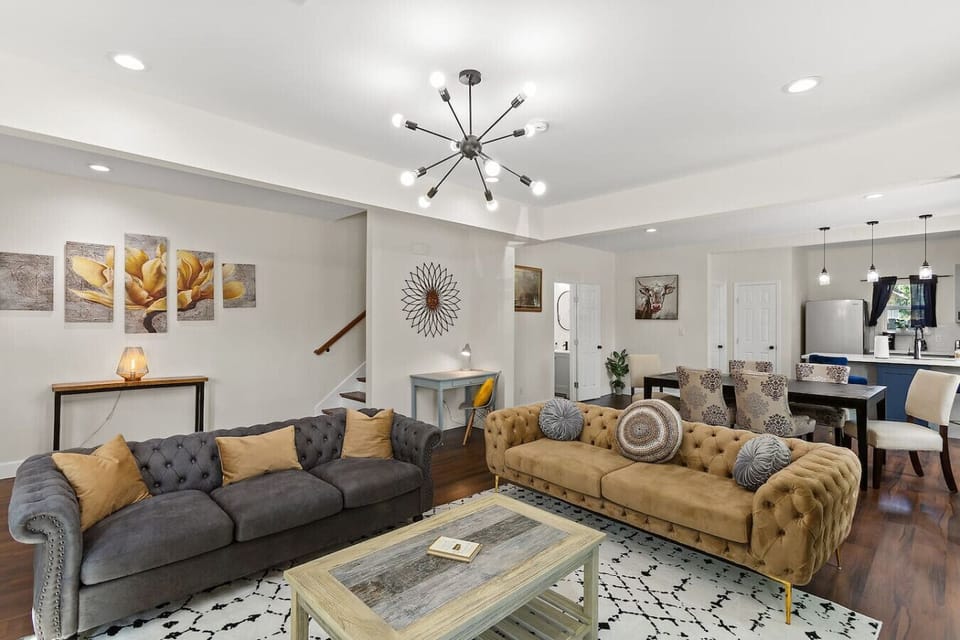 Open layout connects the living room with dining and kitchen areas—ideal for groups to gather, relax, and cook together.