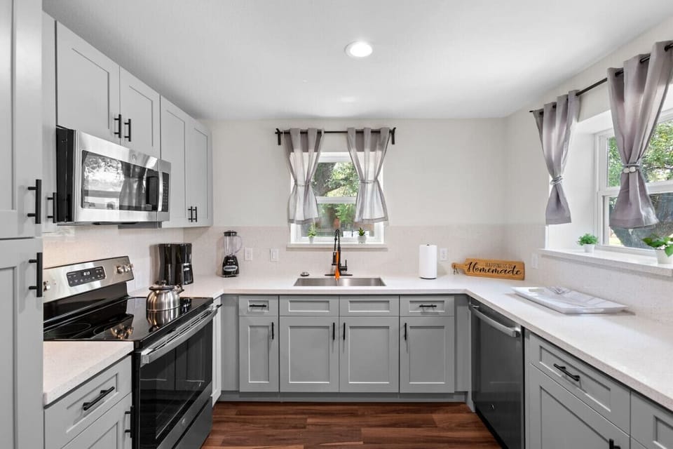 Bright kitchen workspace with generous counter space, abundant cabinetry, and thoughtful layout for cooking together.