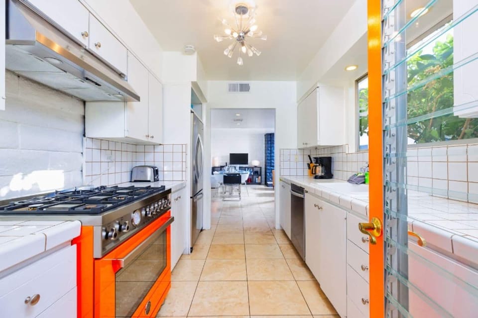 Kitchen is equipped with stainless steel appliances and cooking basics. 