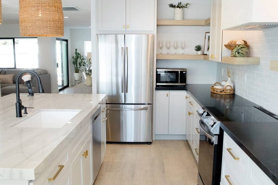 Modern kitchen with stainless steel appliances and contrasting countertops