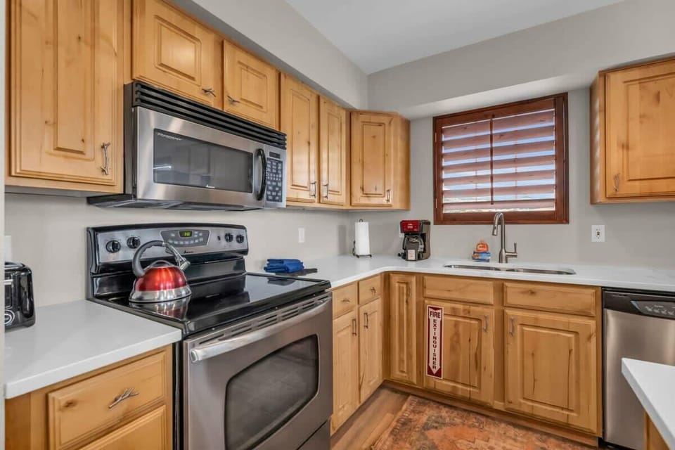 The fully-equipped kitchen features stainless steel appliances, ample counter space, and all the basic cookware needed to prepare a delicious meal.