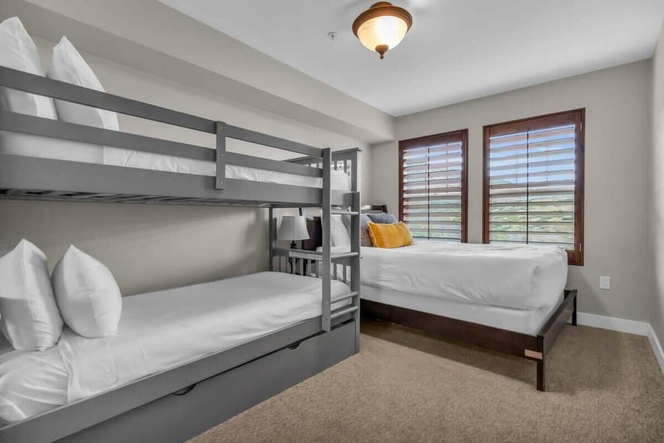 The second bedroom provides plenty of sleeping accommodations with a twin-over-twin bunk bed that includes a trundle mattress, as well as a queen-size bed.