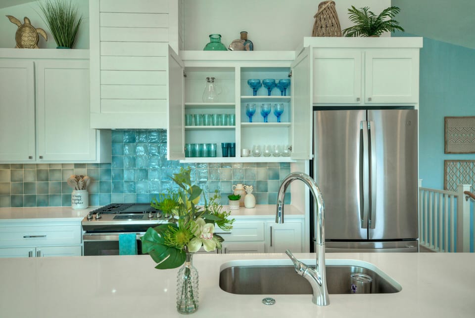 Fully equipped kitchen with beautiful glassware and dinnerware.