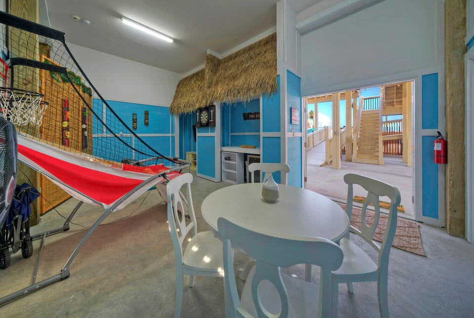 Large outdoor space with dartboard and basketball arcade.