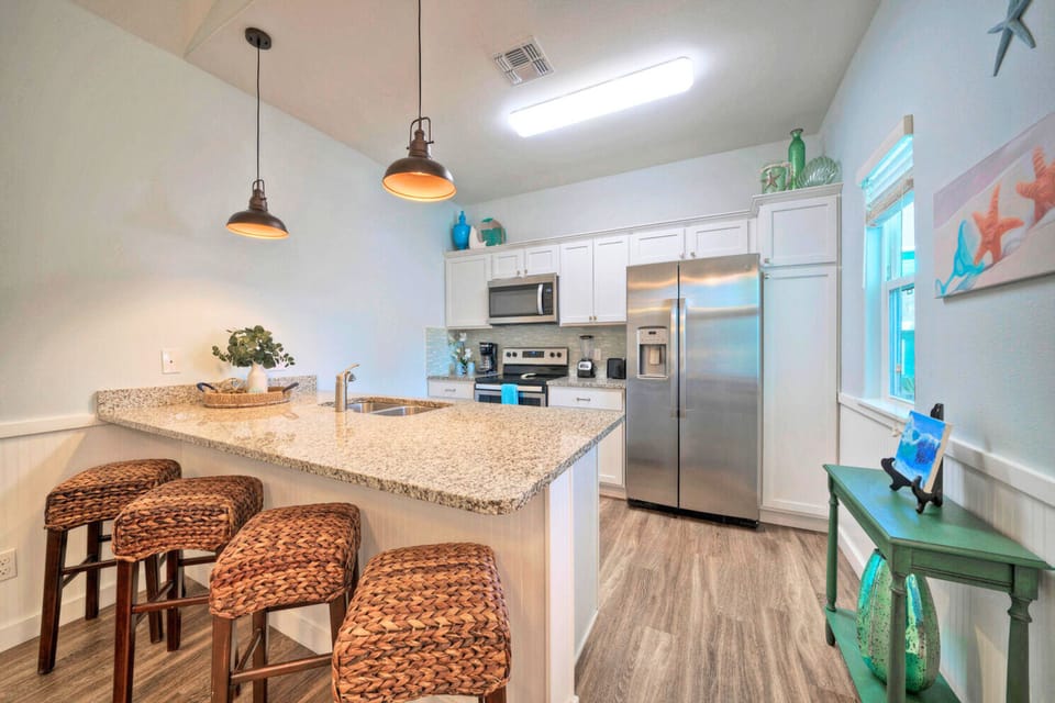 Large kitchen counters with barstool seating.