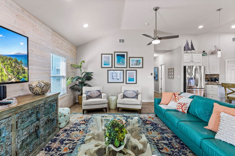 Bright and inviting living room with vaulted ceilings and plenty of seating for gathering together.