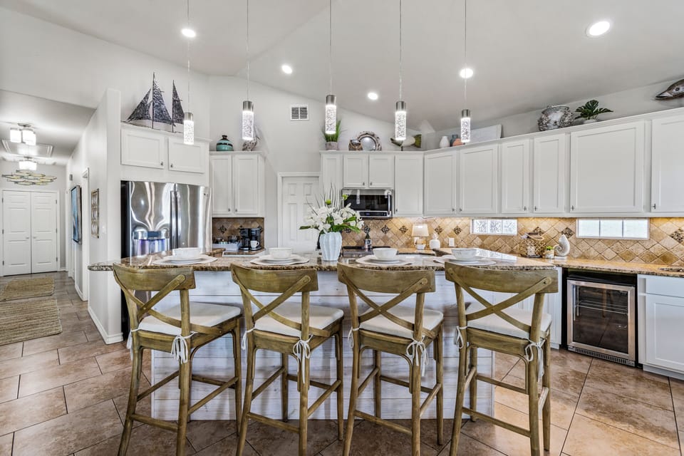 Spacious kitchen with large island seating—perfect for group meals and morning coffee.