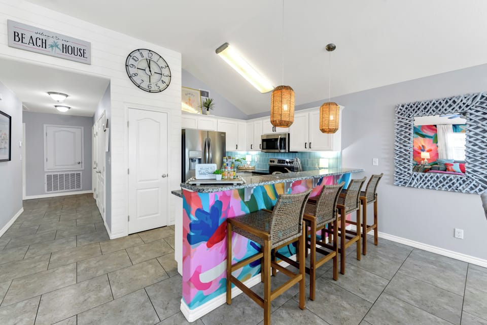 Kitchen features barstool seats.