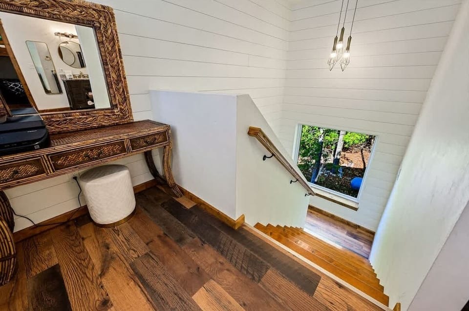Staircase off the main living area leading up to 2 bedrooms and 2 bathrooms